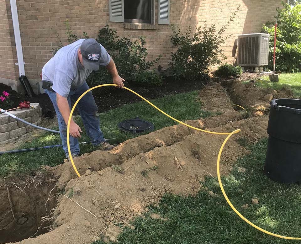 Collett employee installing underground propane tank